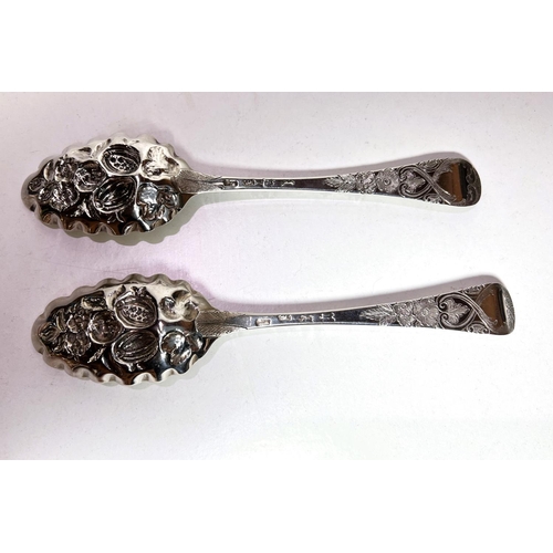 622C - A pair of mid-Georgian embossed and chased hallmarked silver berry spoons. London, date mark unclear... 