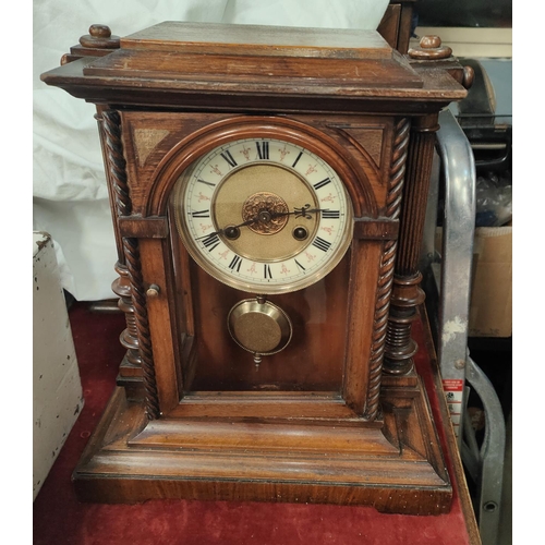 950 - A mahogany mantel clock with chiming movement