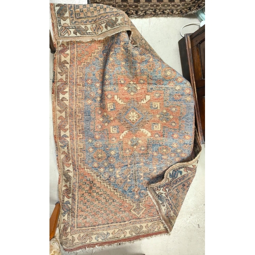 867 - A brown and cream ground middle eastern rug decorated with buildings etc, possibly cut down 150x95cm... 