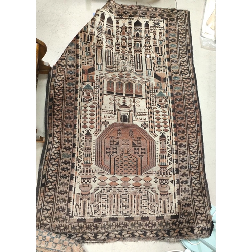 867 - A brown and cream ground middle eastern rug decorated with buildings etc, possibly cut down 150x95cm... 