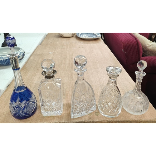 595 - A hall marked silver collared cut Bristol blue decanter, another with decanter with white metal colo... 