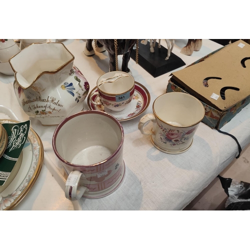 581 - A 19th century English porcelain moustache cup and saucer with pink and gilt floral decoration and a... 