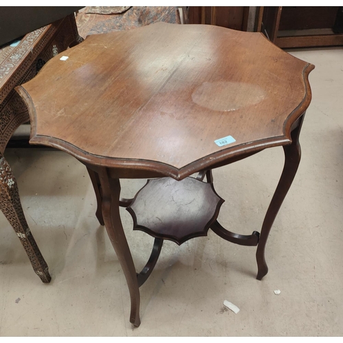 882 - A mahogany circular coffee table; an occasional table/magazine rack; a Victorian footstool; an Edwar... 