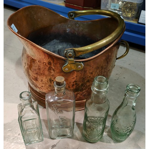 151 - An old copper coal bucket with a selection of 13 various old glass bottles, inc. Manchester brewery ... 