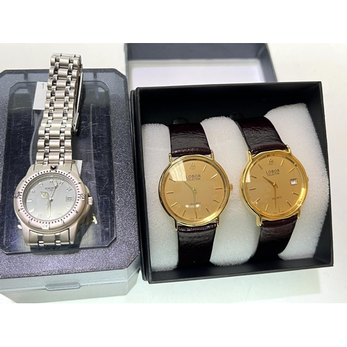 717 - A ladies Sekonda wristwatch with quartz movement, boxed; a pair of Lobor quartz dress watches, boxed