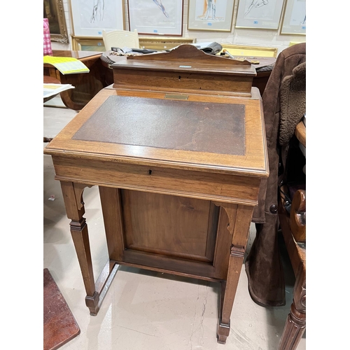 947 - An walnut davenport with sloped writing front drawers to the side, two interior drawers and letter r... 