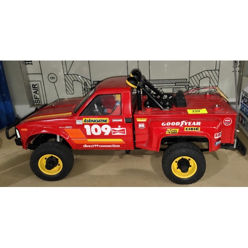 259 - A Tamiya Toyota 4x4 pick up truck 1:10 scale in red (from an estate cannot guarantee working or... 