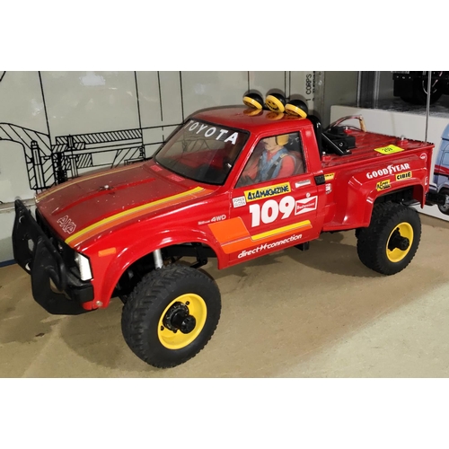 259 - A Tamiya Toyota 4x4 pick up truck 1:10 scale in red (from an estate cannot guarantee working or... 