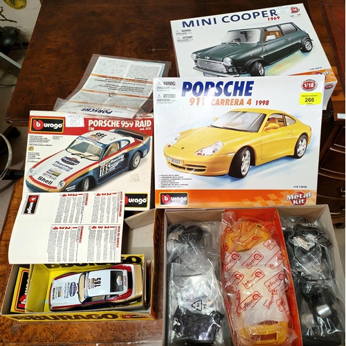 266 - Two boxed Burago Metal kit sets Porsche 911 Carrera 4 1998 and a Mini Cooper 1969, both unmade, and ... 