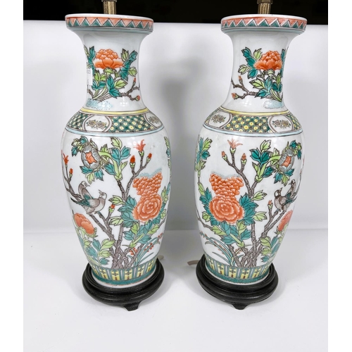 405 - A Chinese pair of porcelain table lamps in the famille verte manner, height 33 cm; and another (a.f.... 