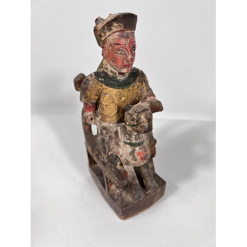 422 - A 19th century Chinese carved wooden figure sat on chair with animal features, with original gilt an... 