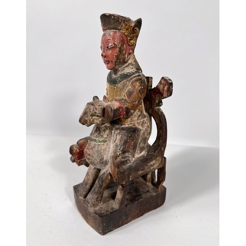 422 - A 19th century Chinese carved wooden figure sat on chair with animal features, with original gilt an... 