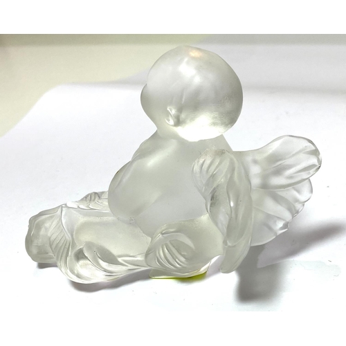 533 - René Lalique:  a reclining figure of a cherub, 11cm