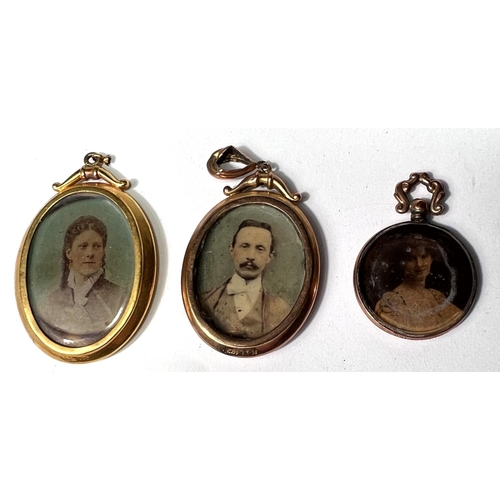 647 - A yellow metal pendant photo locket, double sided, stamped '9ct'; a similar locket, marks unclear; a... 