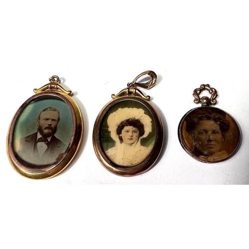 647 - A yellow metal pendant photo locket, double sided, stamped '9ct'; a similar locket, marks unclear; a... 