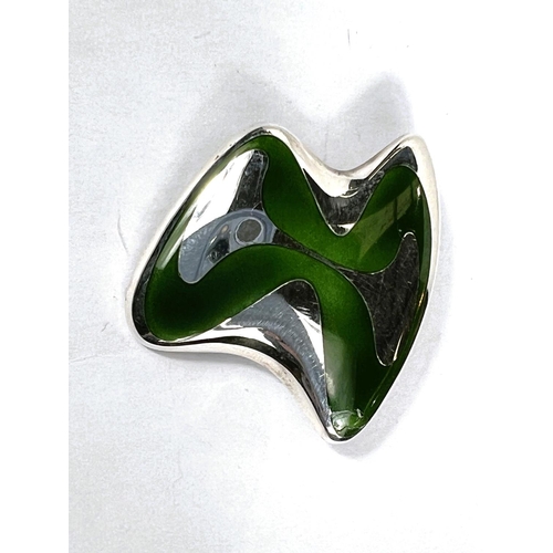 665 - Georg Jensen:  a modernist abstract brooch in silver and green enamel, numbered 315, stamped  H.K., ... 