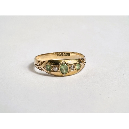 674 - A lady's 18 carat gold dress ring with 3 green tourmalines and 2 diamonds in gypsy style setting, si... 