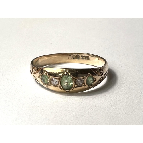 674 - A lady's 18 carat gold dress ring with 3 green tourmalines and 2 diamonds in gypsy style setting, si... 