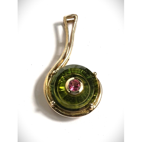 676 - A 9 carat gold pendant formed from a round fern green quartz stone, the centre removed and set with ... 