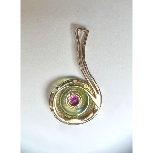 676 - A 9 carat gold pendant formed from a round fern green quartz stone, the centre removed and set with ... 