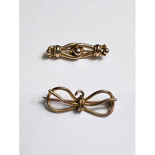 724 - A bar brooch in the form of a bow, stamped '9'; a bar brooch in the form of 2 links, unmarked tests ... 