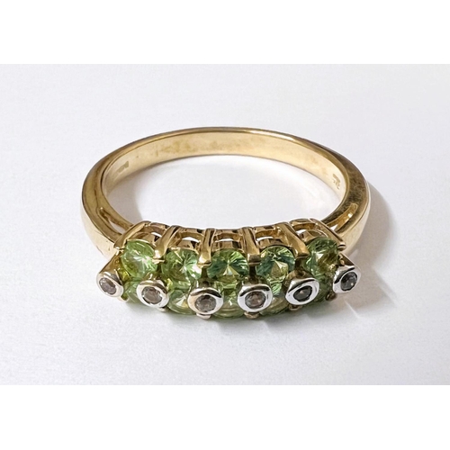 744 - A 9 carat hallmarked gold dress ring set 3 pale green peridot colour oval stones, size N; a 9 carat ... 