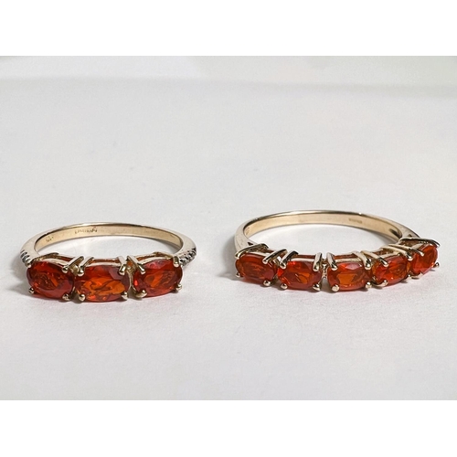 750 - Two 9 carat hallmarked gold dress rings set orange stones, size N & R, weight 3.8g