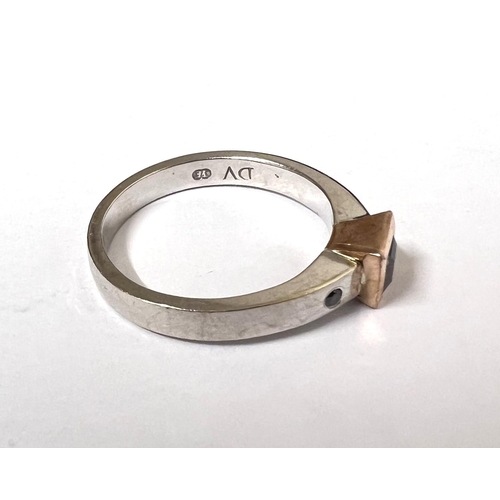 751 - A white metal ring stamped '375' set square champagne diamond in square rose gold mount, flanked by ... 