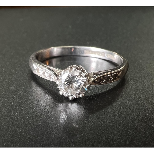 760 - A white metal solitaire diamond ring with 3 graduating diamonds to each shoulder, 3.5gm stamped 