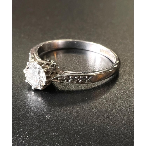 760 - A white metal solitaire diamond ring with 3 graduating diamonds to each shoulder, 3.5gm stamped 