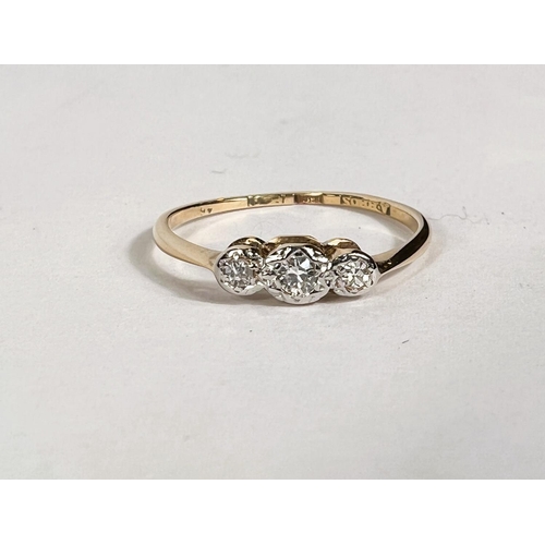 765A - A yellow metal ring stamped 18ct set with 3 diamonds in illusion settings, 1.6gm, size 'N'