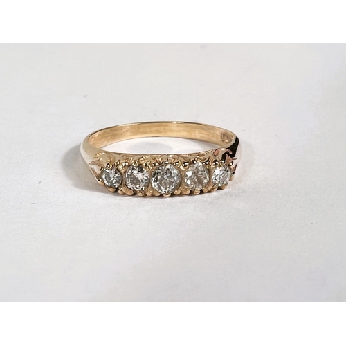 765B - A 9ct hallmarked gold 5 stone diamond ring in split shank setting, 2.9gm, size 'P'