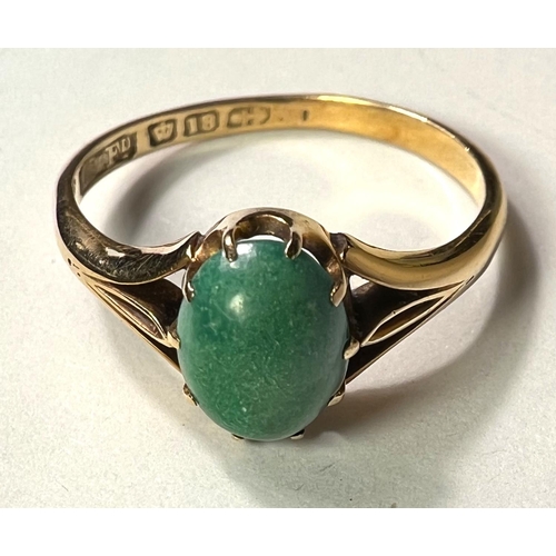 766A - An 18ct hallmarked gold ring set with an oval cabochon Jade coloured stone, 3gm, size 'O'