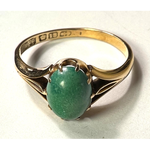 766A - An 18ct hallmarked gold ring set with an oval cabochon Jade coloured stone, 3gm, size 'O'