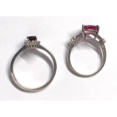 772A - Two 9ct hallmarked white gold rings set with pink stones, 1 triangular with diamond chip to each sho... 