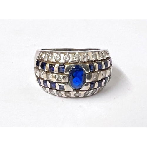 778A - A white ....... ct hallmarked white gold ring set with central blue stone with blue and clear stones... 