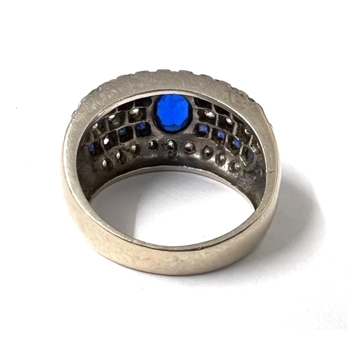 778A - A white ....... ct hallmarked white gold ring set with central blue stone with blue and clear stones... 