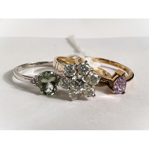 779 - A hallmarked white gold ring with aquamarine coloured central stone and 3 clear stone chips to each ... 