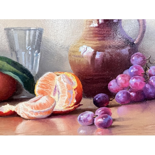 808 - Robert Cailloux 1913:  oranges and grapes in an earthenware jug, oil on board, signed, 25 x 33cm, fr... 