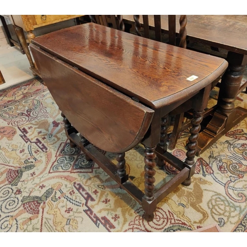 829 - A 1930's oval oak drop leaf barley twist oak dining table.