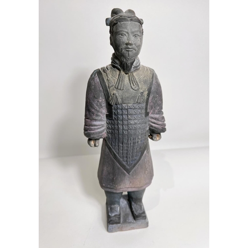 424 - A Chinese ceramic figure of a warrior in the manor of a Terracotta army soldier, height 27cm 