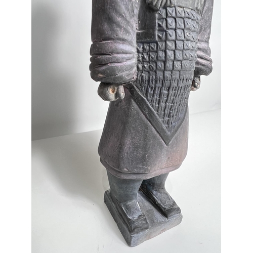 424 - A Chinese ceramic figure of a warrior in the manor of a Terracotta army soldier, height 27cm 