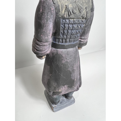 424 - A Chinese ceramic figure of a warrior in the manor of a Terracotta army soldier, height 27cm 