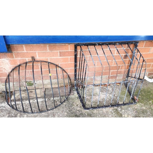 358 - Two cast metal vintage hay racks one squared, one rounded