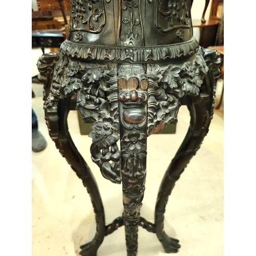 401 - A Chinese tall plant stand in carved and pierced hardwood, with inset marble top, height 97cm