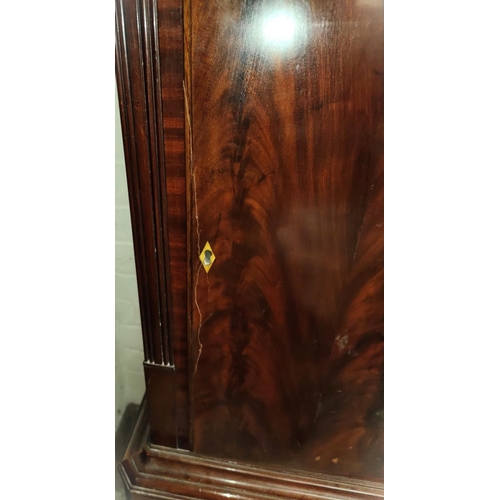 886 - An early 19th century figured mahogany long cased clock, the hood with swan neck pediment and turned... 