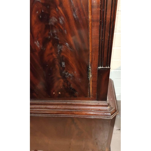 886 - An early 19th century figured mahogany long cased clock, the hood with swan neck pediment and turned... 