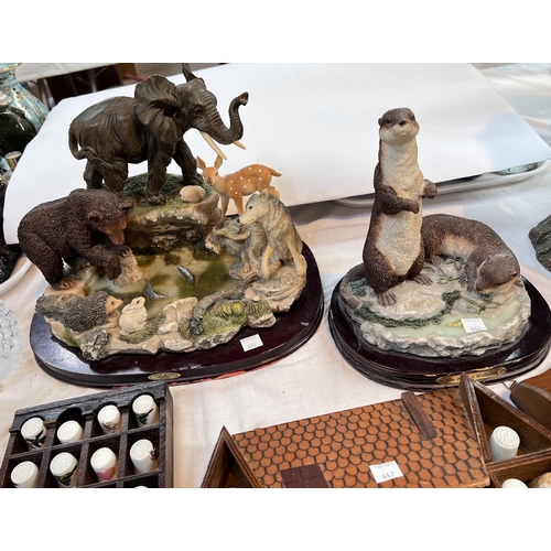 447 - A selection of collectable ceramic thimbles and two resin groups of animals