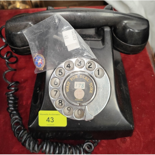 43 - An early 20th century Rotary dial black Bakelite telephone; An enamel egg shaped pendant blue ground... 