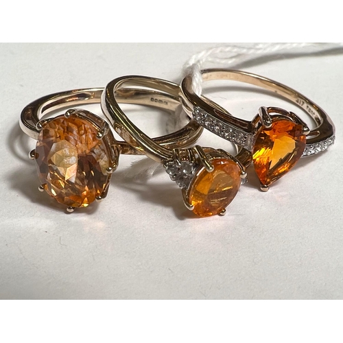 774A - A 9ct hallmarked gold ring set with large oval orange stone Topaz family size R and 2 other 9ct hall... 